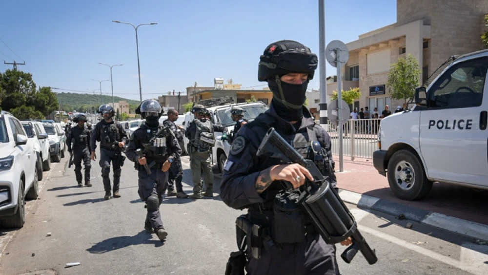 Police stand guard during a protest against the construction of a wind farm near Majdal Shams in the Golan Heights, June 21, 2023. Photo by Ayal Margolin/Flash90.
