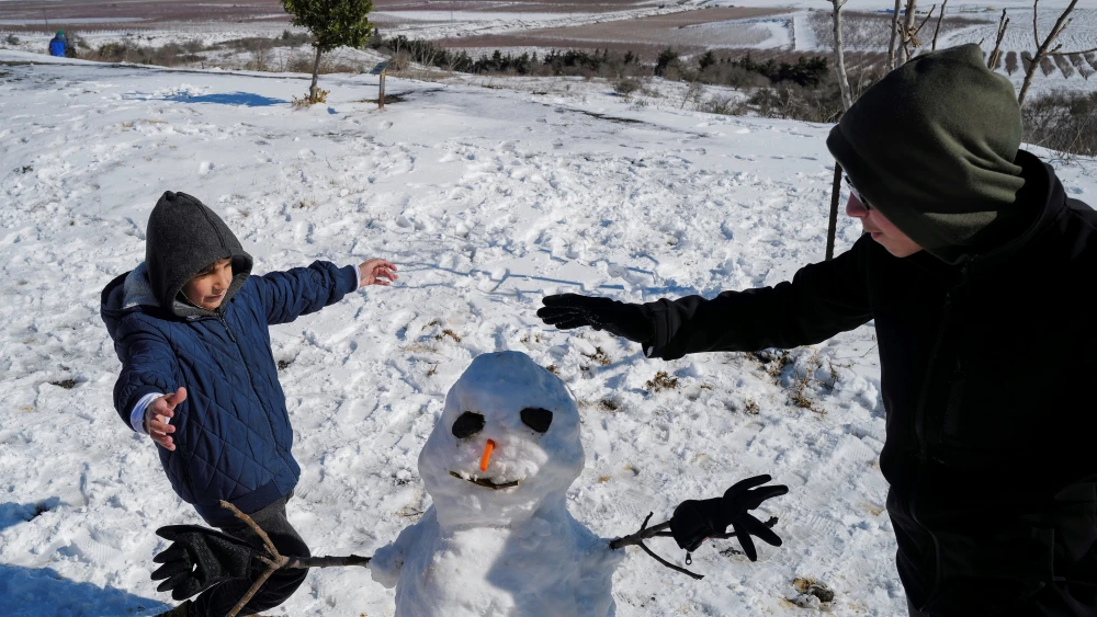 The first snow of the season brings out the snowmen, Jan. 20, 2022. Photo by Michael Giladi/Flash90.