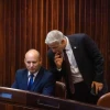 Yamina Party leader Naftali Bennett (seated) and Yesh Atid Party chairman Yair Lapid in the Knesset in Jerusalem during the election for the next Israeli president, June 2, 2021. Photo by Olivier Fitoussi/Flash90.