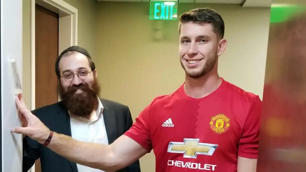 Cleveland Browns placekicker Greg Joseph scored his first game-winning field goal last week with two seconds left in overtime against the Baltimore Ravens. He also made plans to put up a mezuzah at his new home with the help of Chabad Rabbi Yossi Freedman, which they did after the game. Credit: Chabad.org/News.