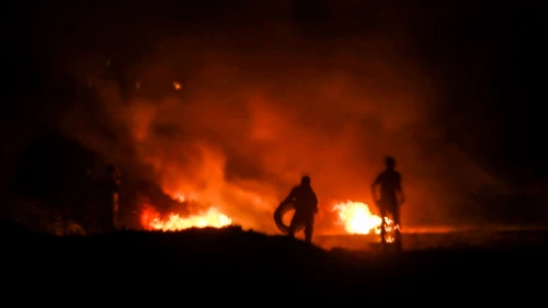 Palestinian protesters burn tires during a night protest near the border with Israel in the southern Gaza Strip, Feb. 14, 2019. Photo by Abed Rahim Khatib/Flash90.