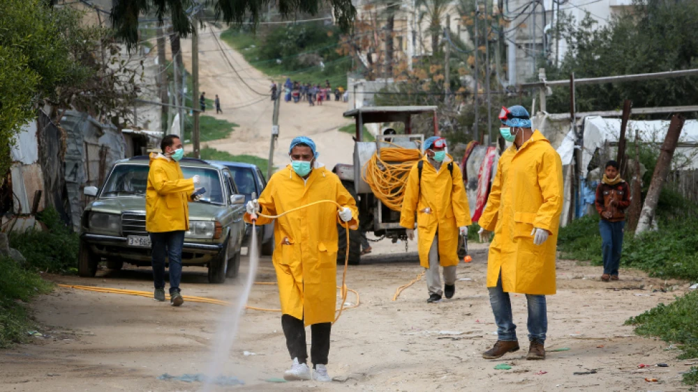 Palestinian health workers spray disinfectant as a precaution against the spread of the COVID-19 virus, in Rafah, southern Gaza Strip, on March 22, 2020. Photo by Abed Rahim Khatib/ Flash90.