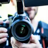 A man holding a camera. Credit: Terje Sollie/Pexels.