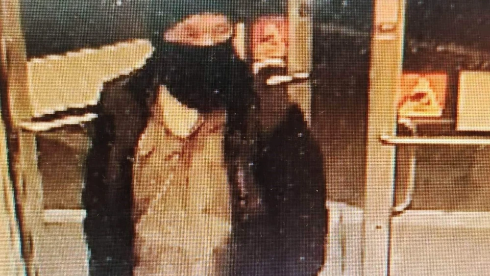 Image of a man in North Carolina wanted for waving a flag with a swastika on it outside of the Temple of the High Country. Credit: Town of Boone Police Department.