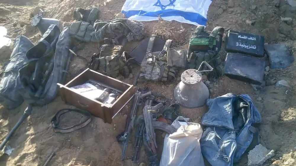 Materiel found by Israeli forces in the Gaza Strip, next to an Israeli flag. Credit: IDF Spokesperson's Unit.