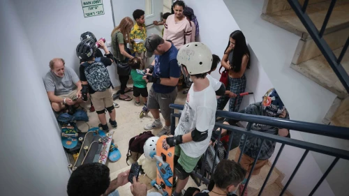 Israelis take cover inside a bomb shelter as an air-raid siren sounds in Tel Aviv, Oct. 26, 2023. Photo by Noam Revkin Fenton/Flash90.