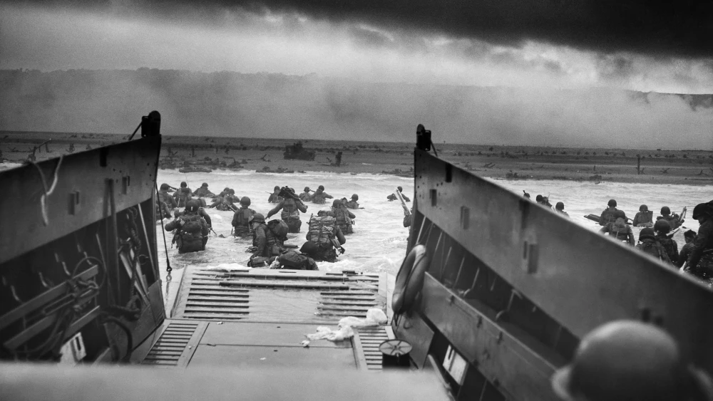 American troops in a U.S. Coast Guard landing craft approach Omaha Beach under fire during the D-Day invasion of German-occupied France on June 6, 1944. Credit: U.S. National Archives via Wikimedia Commons.