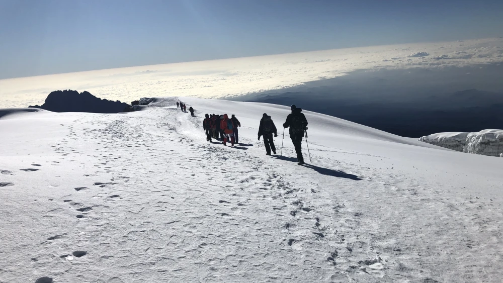 A view of the team hiking across the snow fields on the top of Kilimanjaro. Credit: Friends of Access Israel.