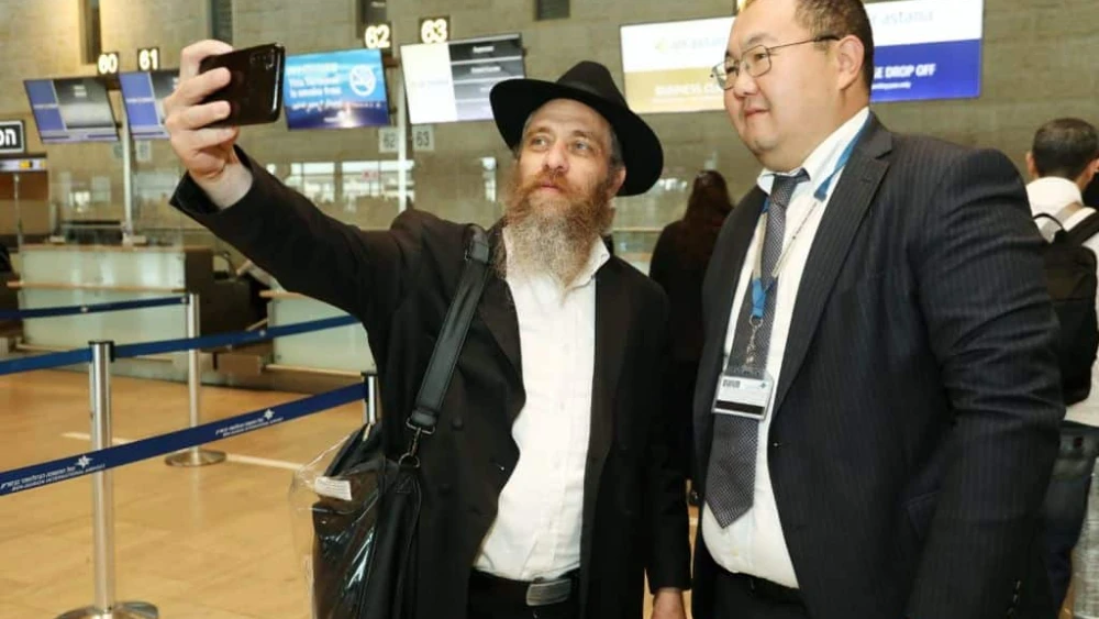 Israeli passengers at Tel Aviv's Ben-Gurion International Airport celebrate with Air Astana staff the inaugural direct flight between Israel and Kazakhstan on Sept. 7, 2023. Photo by Gideon Markowicz/TPS.