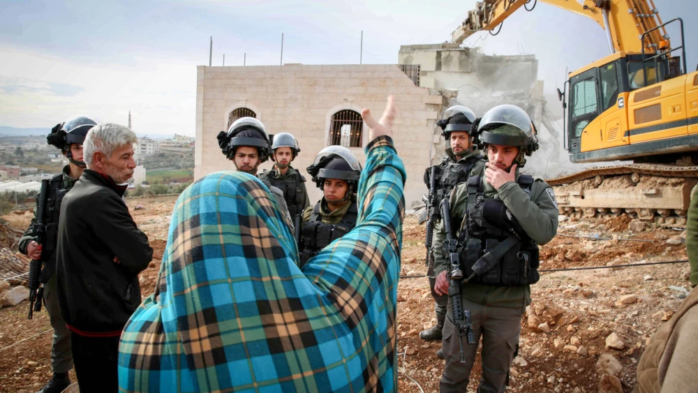 The demolition of an illegally built structure in the Judea city of Hebron, Dec. 28, 2021. Photo by Wisam Hashlamoun/Flash90.