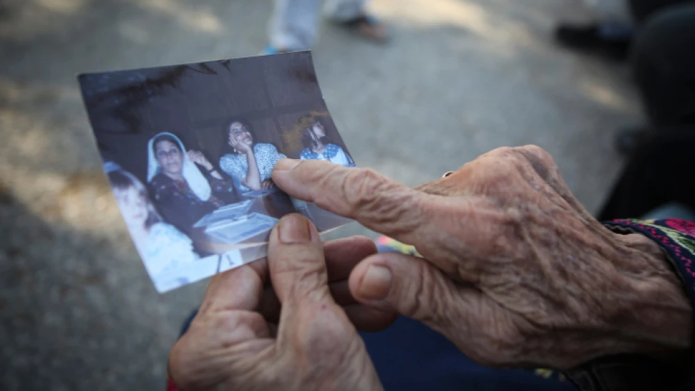 Muftia, the grandmother of Rep. Rashida Tlaib, holds a picture outside her house in the village of Beit Ur Al-Fauqa near Ramallah in Samaria, Aug. 16, 2019. Photo by Flash90.