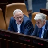 Foreign Minister Yair Lapid and Defense Minister Benny Gantz attend a plenum session at the Knesset in Jerusalem on June 20, 2022. Photo by Yonatan Sindel/Flash90.