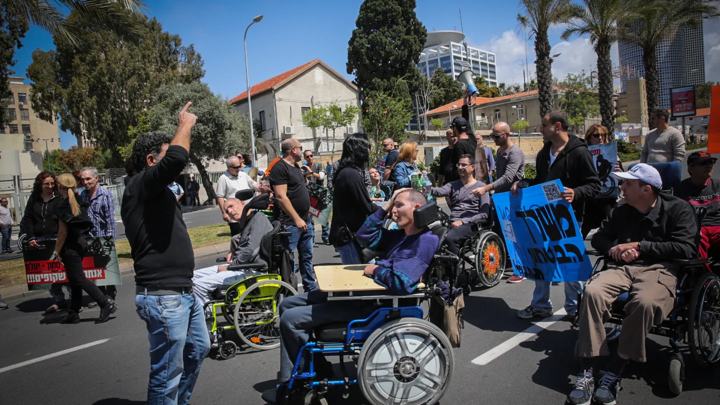 Disabled veteran Israel Defense Forces soldiers and their assistants protest outside the Defense Ministry in Tel Aviv, on March 29, 2016. Photo by Yossi Zamir/Flash90.