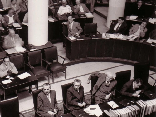 The Knesset plenum at Frumin House in Jerusalem in 1952. From bottom left to right: Haim-Moshe Shapira, Moshe Sharet, David Ben-Gurion and Ze’ev Sherf. Credit: Public Domain via Wikimedia Commons.