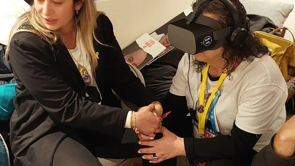 Hamas hostage Shlomi’s Ziv's mother Rozita views "Shlomi's Glasses" for the first time, together with her neice, Liat Ariel, who created the 8-minute virtual reality experience. Photo courtesy of Liat Ariel.