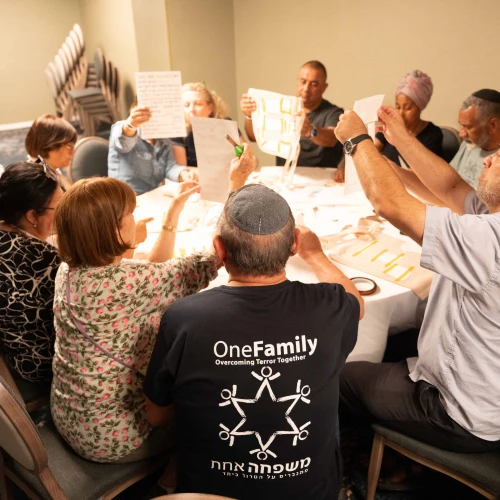 Bereaved families comfort one another at OneFamily's pre-Memorial Day retreat at the Kinneret. Photo by Meir Pavlovsky.