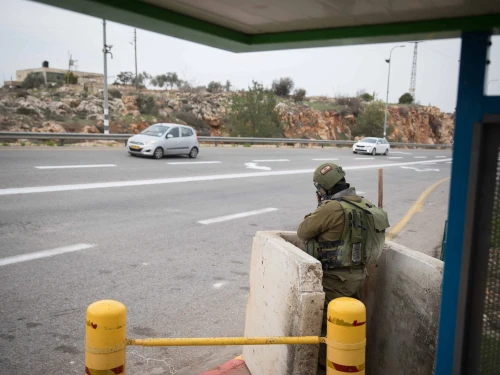 Israeli soldiers guard a bus stop on Route 60 near the entrance to the Israeli community of Ofra in Samaria, Dec. 16, 2018. Photo by Hadas Parush/Flash90.