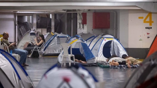 People take shelter in an underground parking lot in Tel Aviv during the war between Israel and Iran, June 24, 2025. Photo by Chaim Goldberg/Flash90.