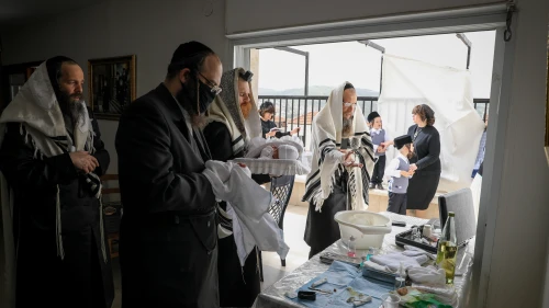 The Greenfeld family celebrate a brit milah at their home in Beitar Illit, Israel, on April 5, 2020. Photo by Nati Shohat/Flash90.