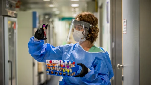 A technician carries out a diagnostic test for coronavirus in a lab at the Ichilov Hospital in Tel Aviv on Aug. 3, 2020. Photo by Yossi Aloni/Flash90.
