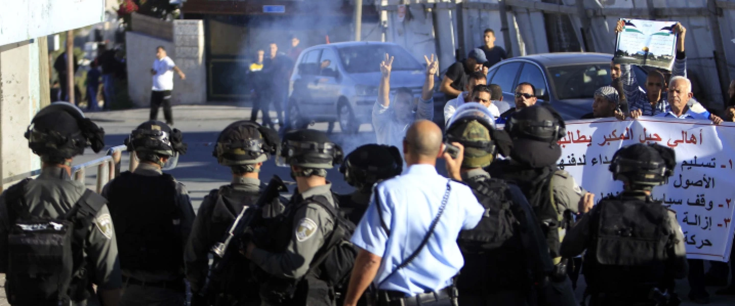 Palestinian men shout during clashes with Israeli security forces at a protest in the eastern Jerusalem neighborhood of Jabel Mukaber, demanding they be given the bodies of the Palestinian men killed in terror attacks. Nov. 13, 2015. Photo by Muammar Awad/Flash90.