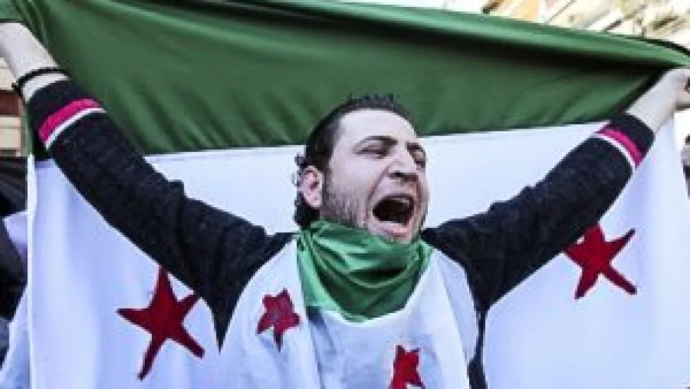 Anti-Syrian regime protester chants slogans against Syrian President Bashar Assad. Credit: Freedom House via Flickr.