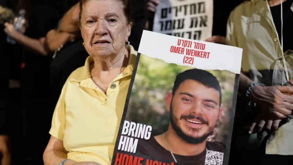Holocaust survivor Tzili Wenkert holds a placard depicting her grandson Omer Wenkert, whom Hamas is holding captive in the Gaza Strip, at an event at "Hostages Square" outside the Tel Aviv Museum of Art on Oct. 28, 2023. Photo by Gili Yaari/Flash90.