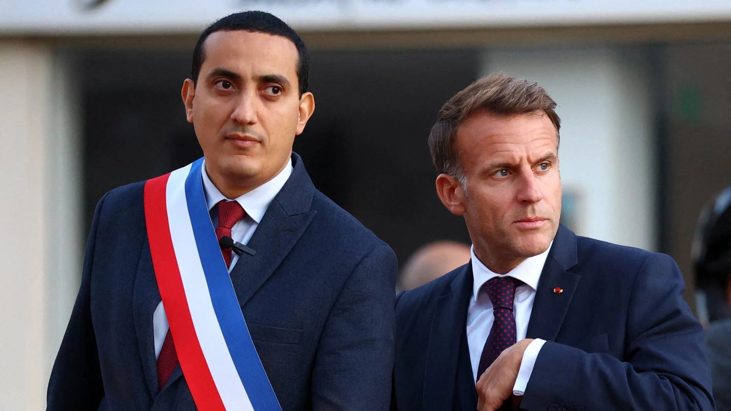 Photo: JNS.org France's President Emmanuel Macron walks with the Mayor of Trappes, Ali Rabeh (left), as he arrives for a meeting at the