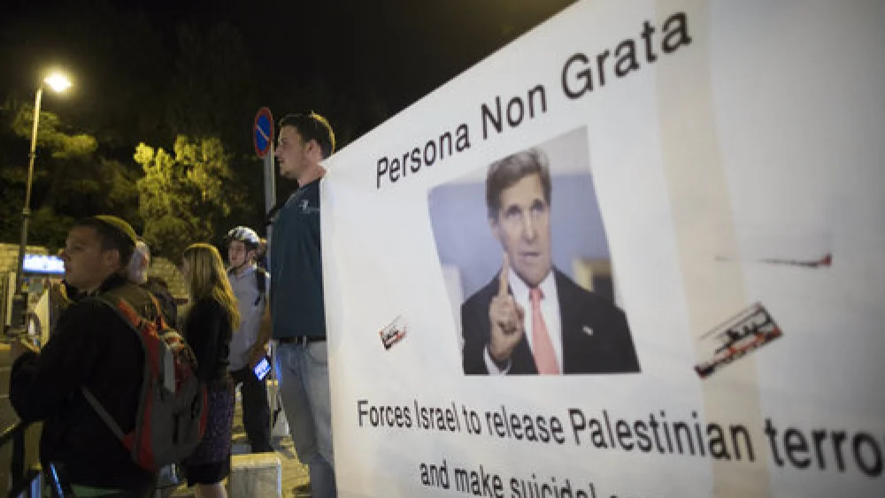 Israeli protesters hold banners when U.S. Secretary of State John Kerry was in Jerusalem for peace talks March 31, 2014. Credit: Yonatan Sindel/Flash90.