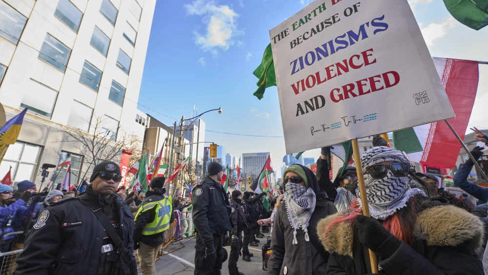 Police form a barrier between Al-Quds day protesters and pro-Israel counter protestors near the U.S. Consulate in Toronto, Ontario, on March 14, 2026. Photo by Geoff Robins / AFP via Getty Images.