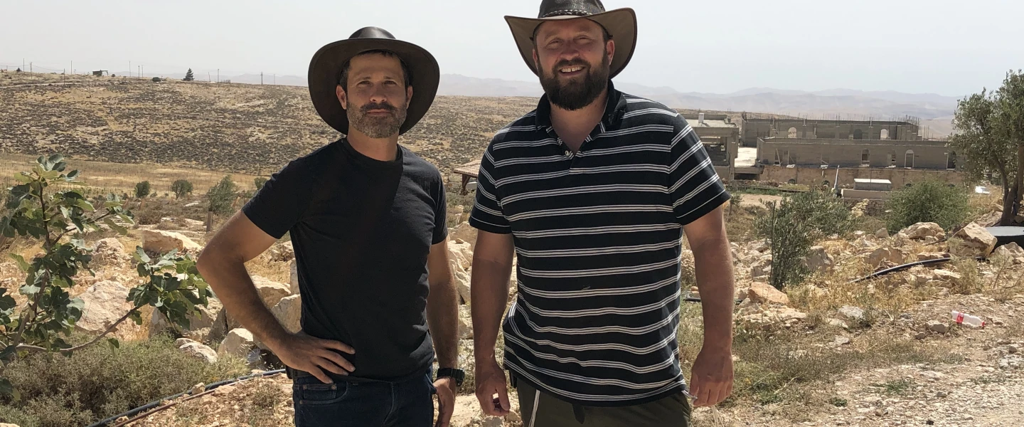 Jeremy Gimpel (left) and Ari Abramowitz on their property, Arugot Farms, in the Judean Desert. Photo by Josh Hasten.