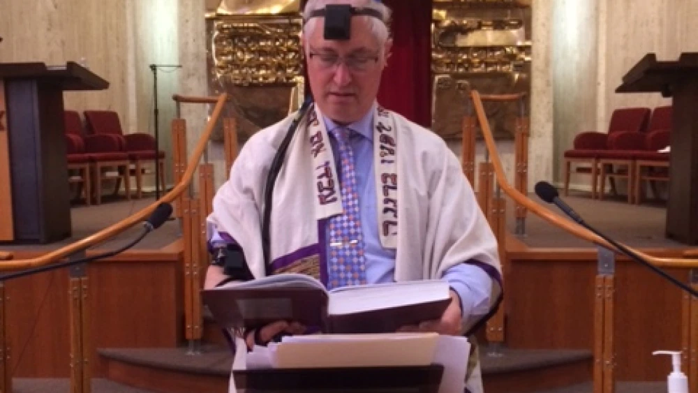 Rabbi Michael Beals leading daily services alone in the sanctuary of Congregation Beth Shalom in Wilmington, Del. Credit: Courtesy.