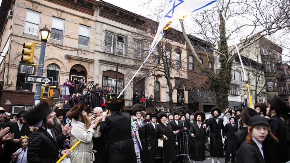 Haredi Jewish men burn an Israeli flag in the Williamsburg section of Brooklyn, N.Y., on March 1, 2018. Photo by Amir Levy/Flash90.