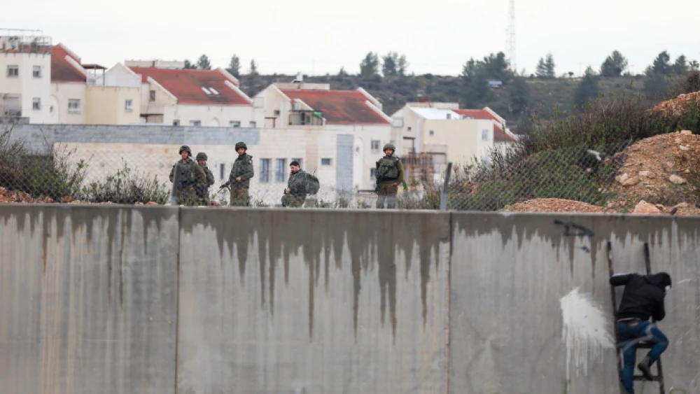 Palestinians clash with Israeli security forces near the security barrier during a protest in the village of Bilin in the West Bank on Feb. 7, 2020. Photo by Flash90.