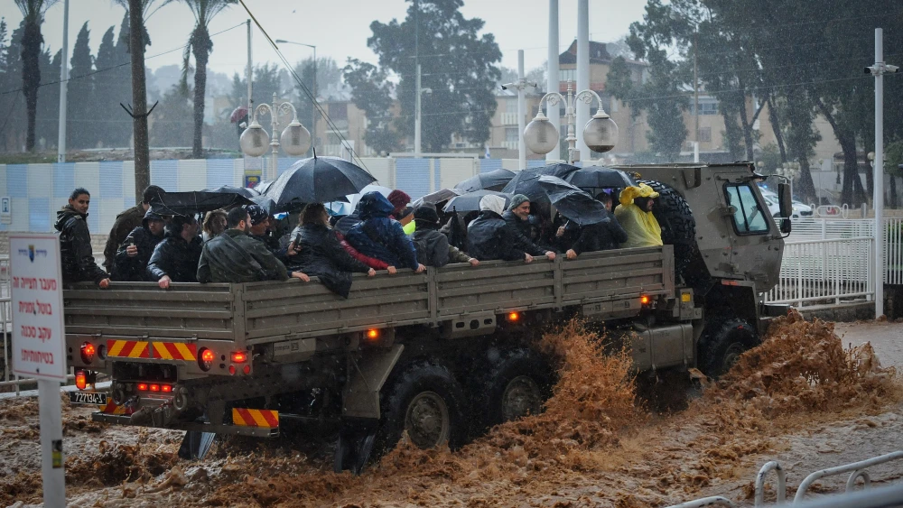 A military truck evacuates Israeli citizens through a flooded road in the northern Israeli city of Nahariya on Jan. 8, 2020. Photo by Meir Vaknin/Flash90.