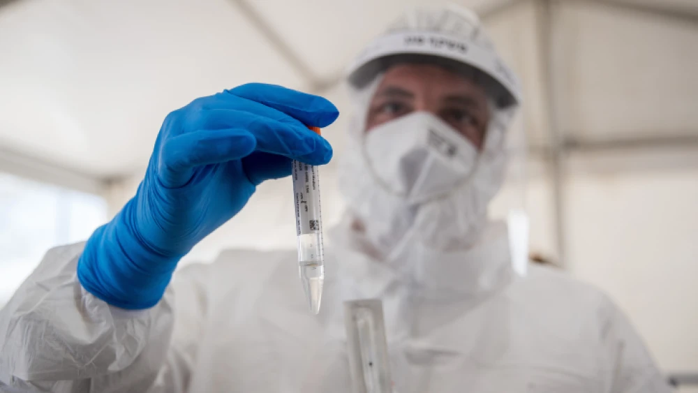 A Magen David Adom medical worker conducts coronavirus tests at the entrance to the easterm Jerusalem village of Jabel Mukaber, on April 2, 2020. Photo by Yonatan Sindel/Flash90.