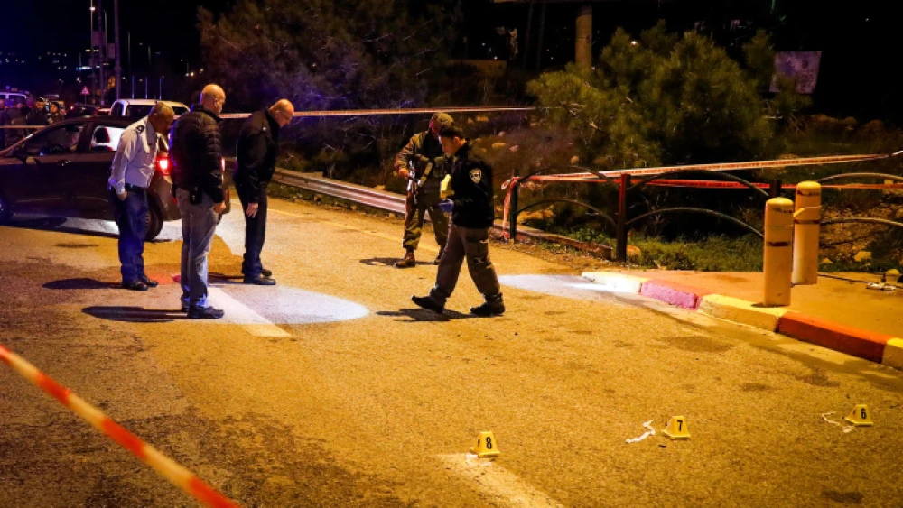 Israeli soldiers and police inspect the scene of a shooting attack at the entrance to the Israeli town of Ofra, north of Ramallah, in Judea and Samaria on Dec. 9, 2018. Photo by Ofer Meir/Flash90.