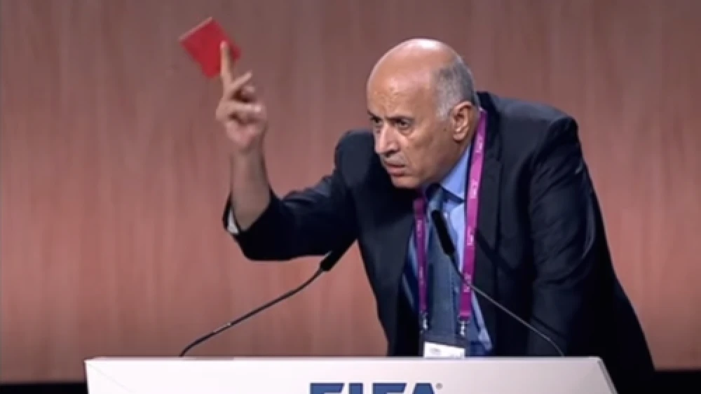 Palestinian soccer official Jibril Rajoub waives a symbolic red penalty card at Israel during the 65th FIFA Congress in 2015. Credit: YouTube.