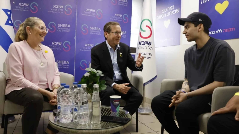 Israeli President Isaac Herzog, center, and his wife, Michal Herzog, talk with freed hostage Yosef-Haim Ohana at Sheba Medical Center in Ramat Gan on Oct. 17, 2025. Source: @Isaac_Herzog/X.