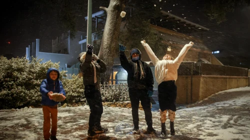 Kids play in the snow in the northern Israeli city of Tzfat on Jan. 19, 2022. Photo by David Cohen/Flash90.