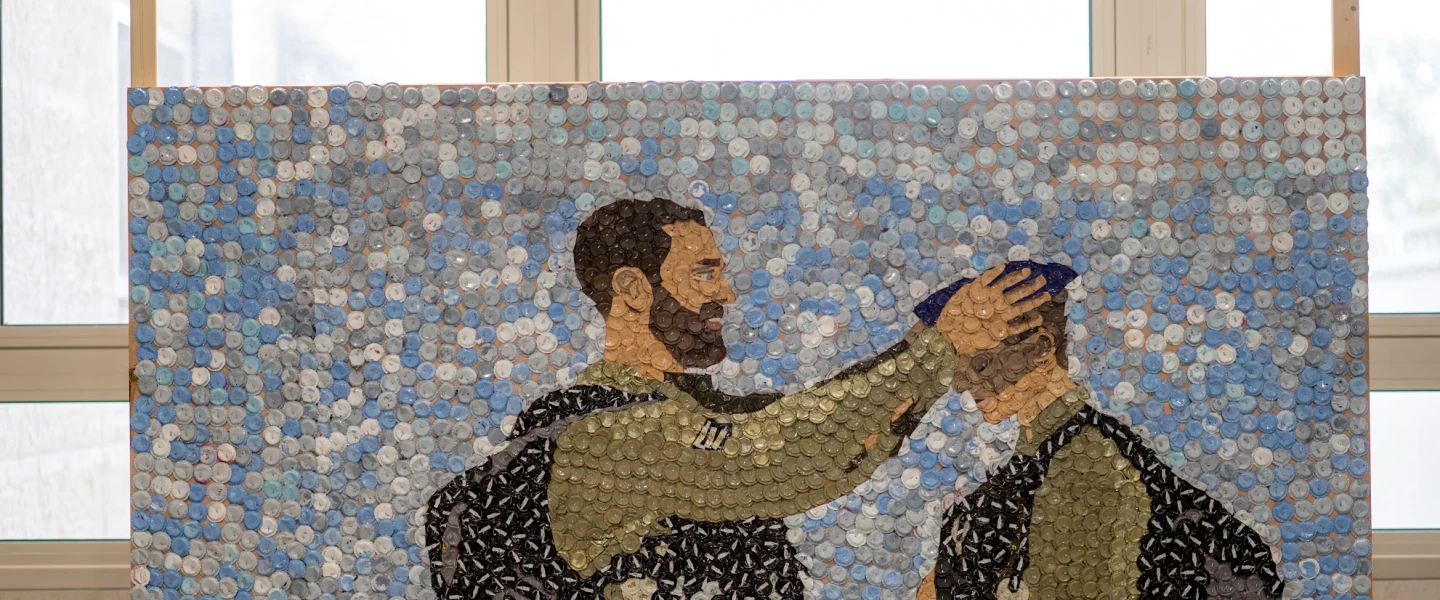 'Metal Caps on Wood' by Hallel Shayon commemorates her childhood friend Dotan Shimon, who was killed in Rafah during the Gaza war in 2024. Made from bottle caps collected over seven years, the piece uses these everyday objects to represent memories that build up over time and turns personal grief into a shared act of remembrance. Credit: Courtesy of Ohr Torah Stone.