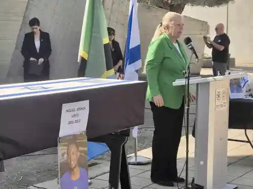 Head of MASHAV Eynat Shlein speaks at the farewell ceremony for Tanzanian agricultural intern Joshua Luito Mollel at Ben-Gurion Airport, Nov. 18, 2025, honoring his memory and expressing condolences on behalf of Israel’s international development agency. Source: @EynatShlein/X.
