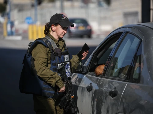 An Israeli soldier from the Erez Battalion in the Military Police checks IDs and Palestinian vehicles at the checkpoint to the Shuafat Refugee Camp in eastern Jerusalem on Dec. 22, 2015. Credit: Hadas Parush/Flash90.