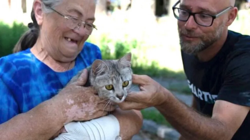 SmartAID Director Shachar Zahavi with a woman who lived in the bombed-out building seen behind them in Hostomel, Ukraine. Photo courtesy of SmartAID