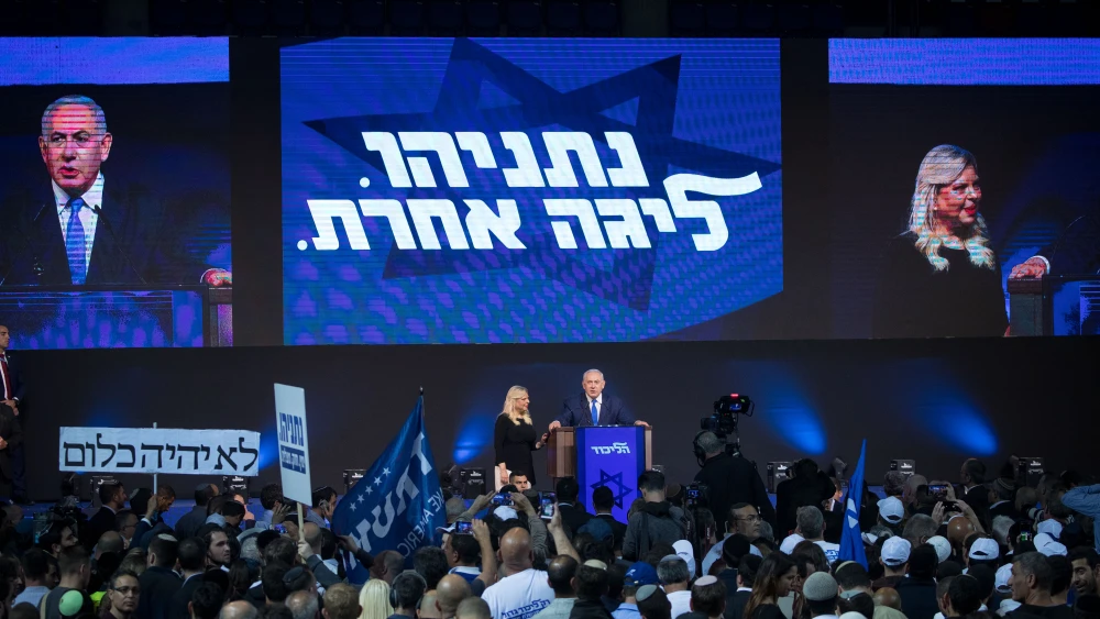 Israeli Prime Minister Benjamin Netanyahu, with his wife, Sara, next to him, addresses supporters as the the results of Israel's national elections are announced at party headquarters in Tel Aviv on April 9, 2019. Photo by Yonatan Sindel/Flash90.