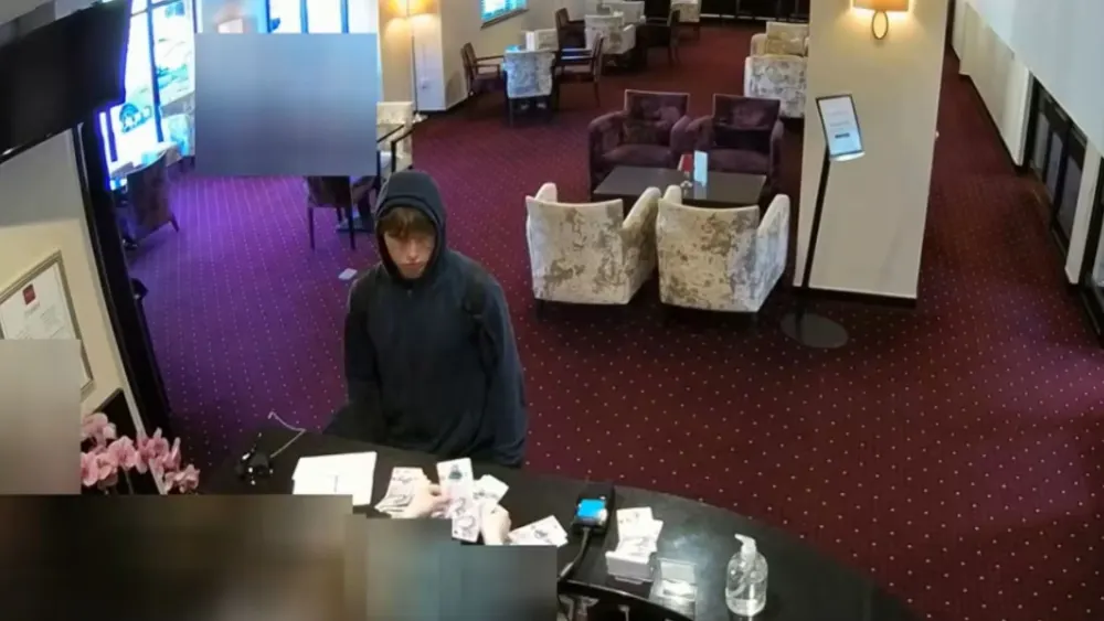 Johannes Natland at the reception desk of the Briar Court Hotel in Huddersfield, England. Credit: Metropolitan Police.