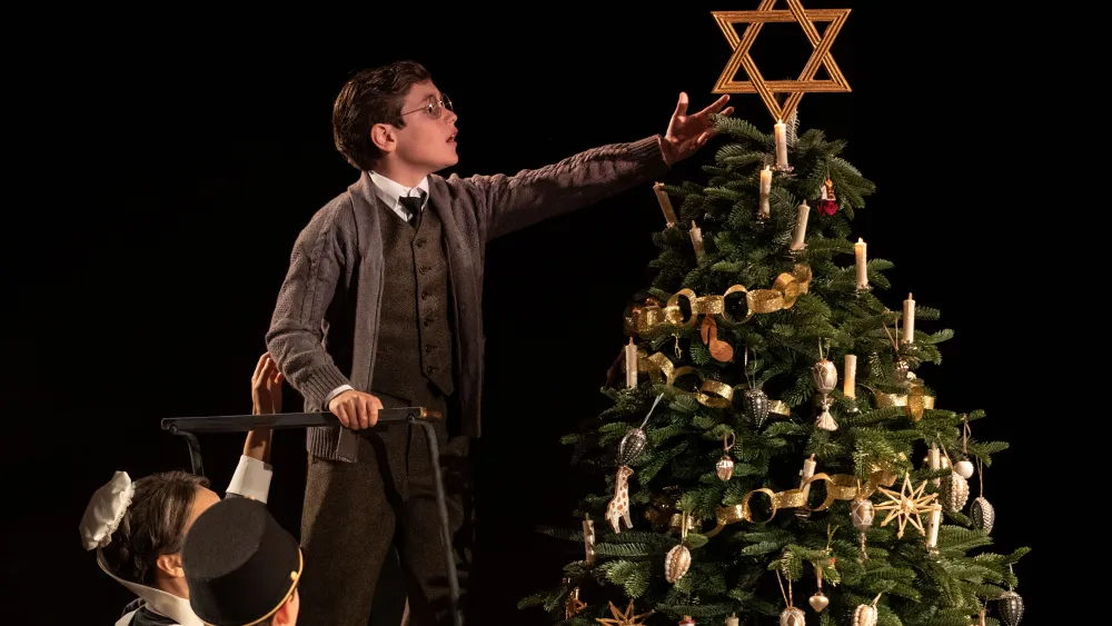 A scene from the play "Leopoldstadt," which opens in 1899 at a family Christmas party, where one of the children places a large Star of David atop the tree. Credit: "Leopoldstadt."