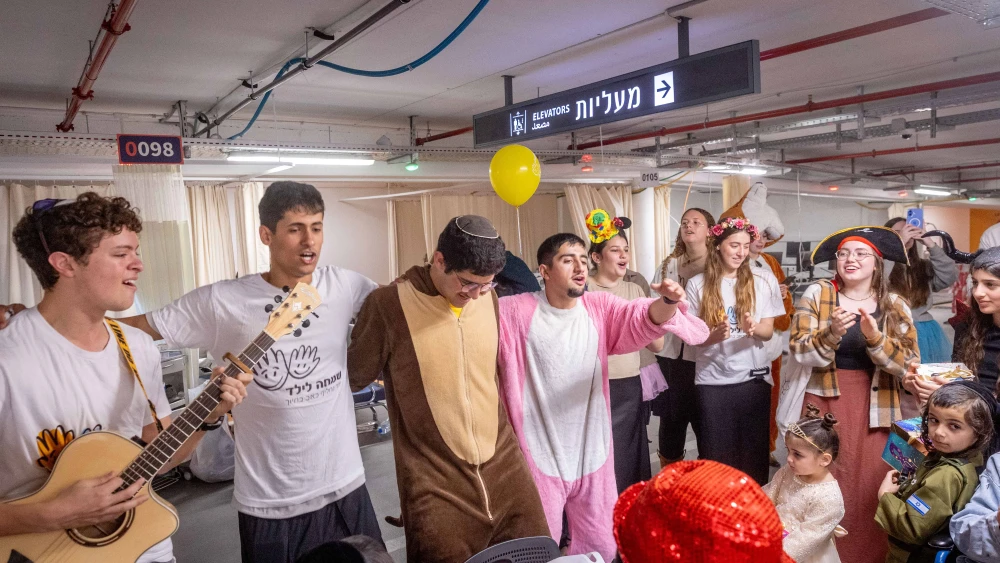 Celebrating Purim in an underground parking area converted to a treatment ward at Shaarei Tzedek Medical Center in Jerusalem, March 4, 2026. Photo by Chaim Goldberg/Flash90.