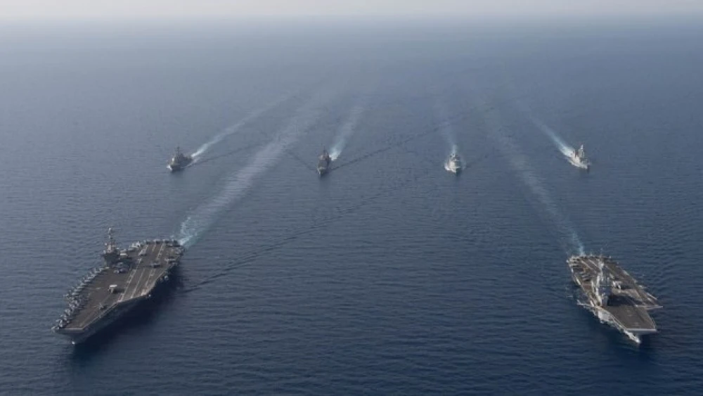French Navy’s Charles de Gaulle Carrier Strike Group (right) and the U.S. Navy’s John C. Stennis Carrier Strike Group participated in a naval passing exercise (PASSEX) in the Red Sea, April 15, 2019.