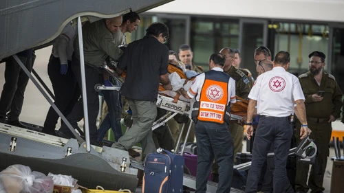 Israeli soldiers and ZAKA emergency response volunteers carry an Israeli upon arrival from Turkey at Ben-Gurion Airport on Sunday. Three Israeli tourists were killed in a suicide-bombing in Istanbul on Saturday. Credit: Hadas Parush/Flash90.